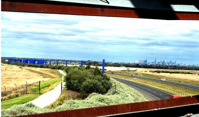 Melbourne City skyline from Whittlesea Gardens Footbridge over the Hume Freeway